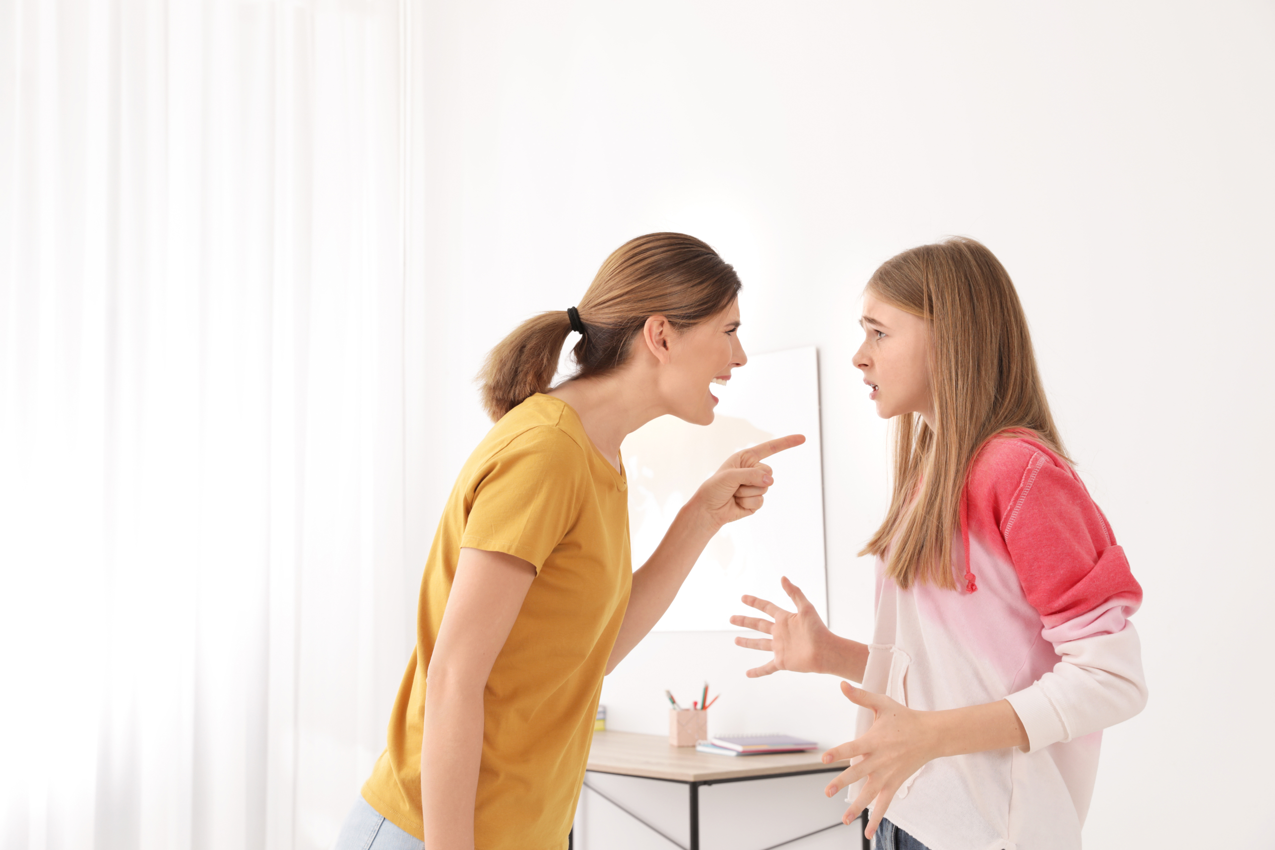 Mother scolding her teenager daughter at home