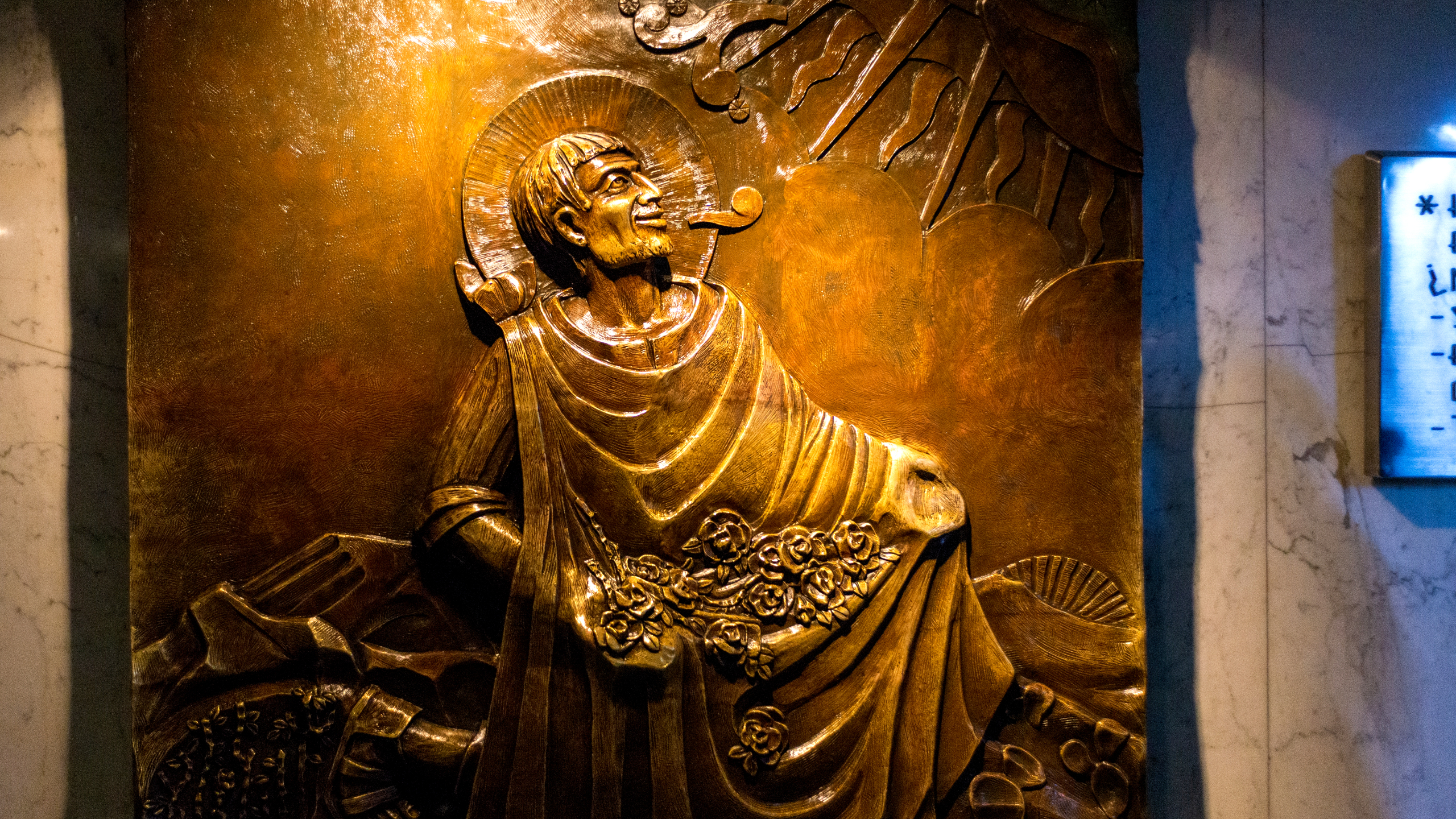 Bronze relief of Saint Juan Diego receiving the revelation of th