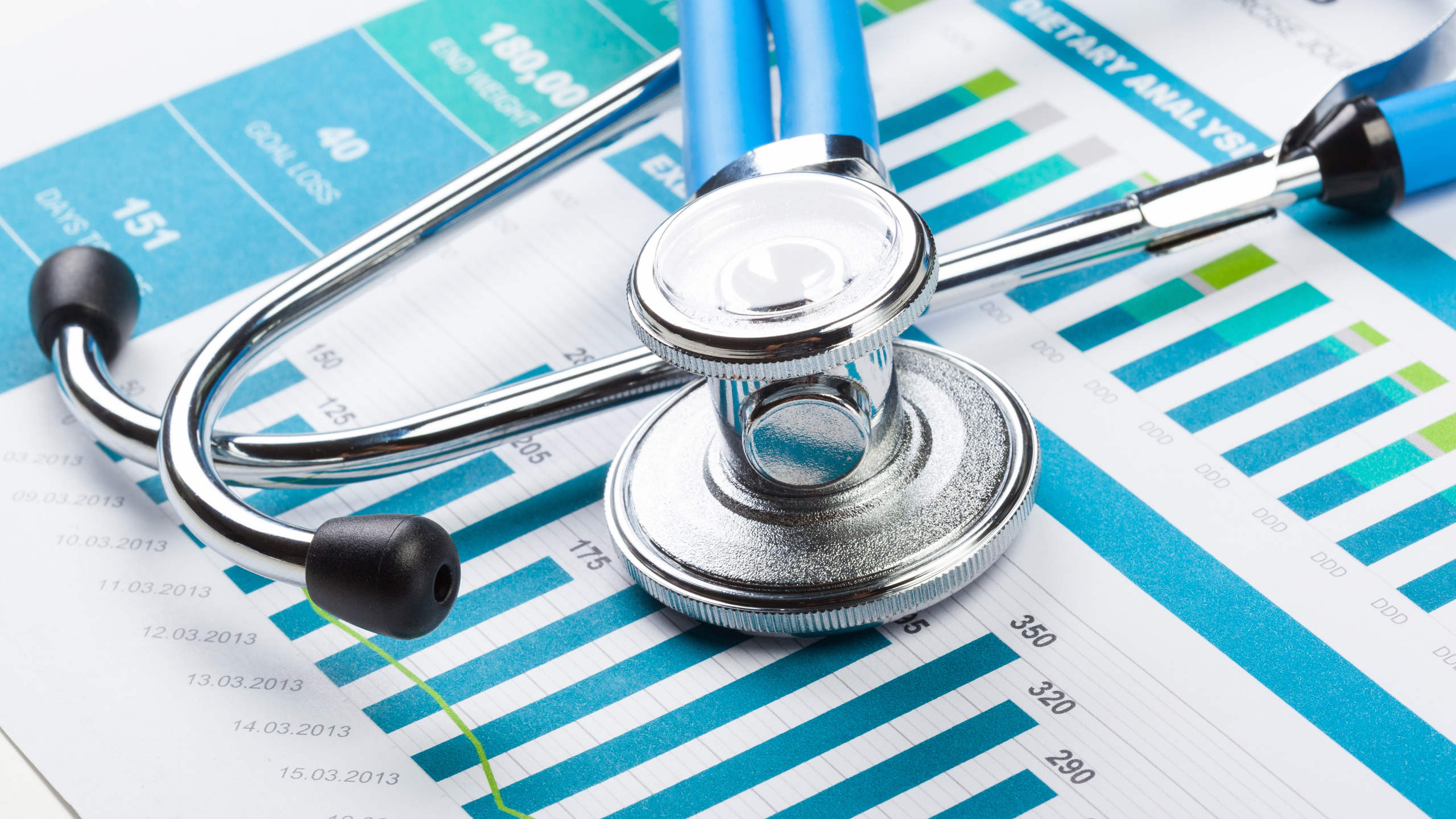Stethoscope with financial on the desk.
