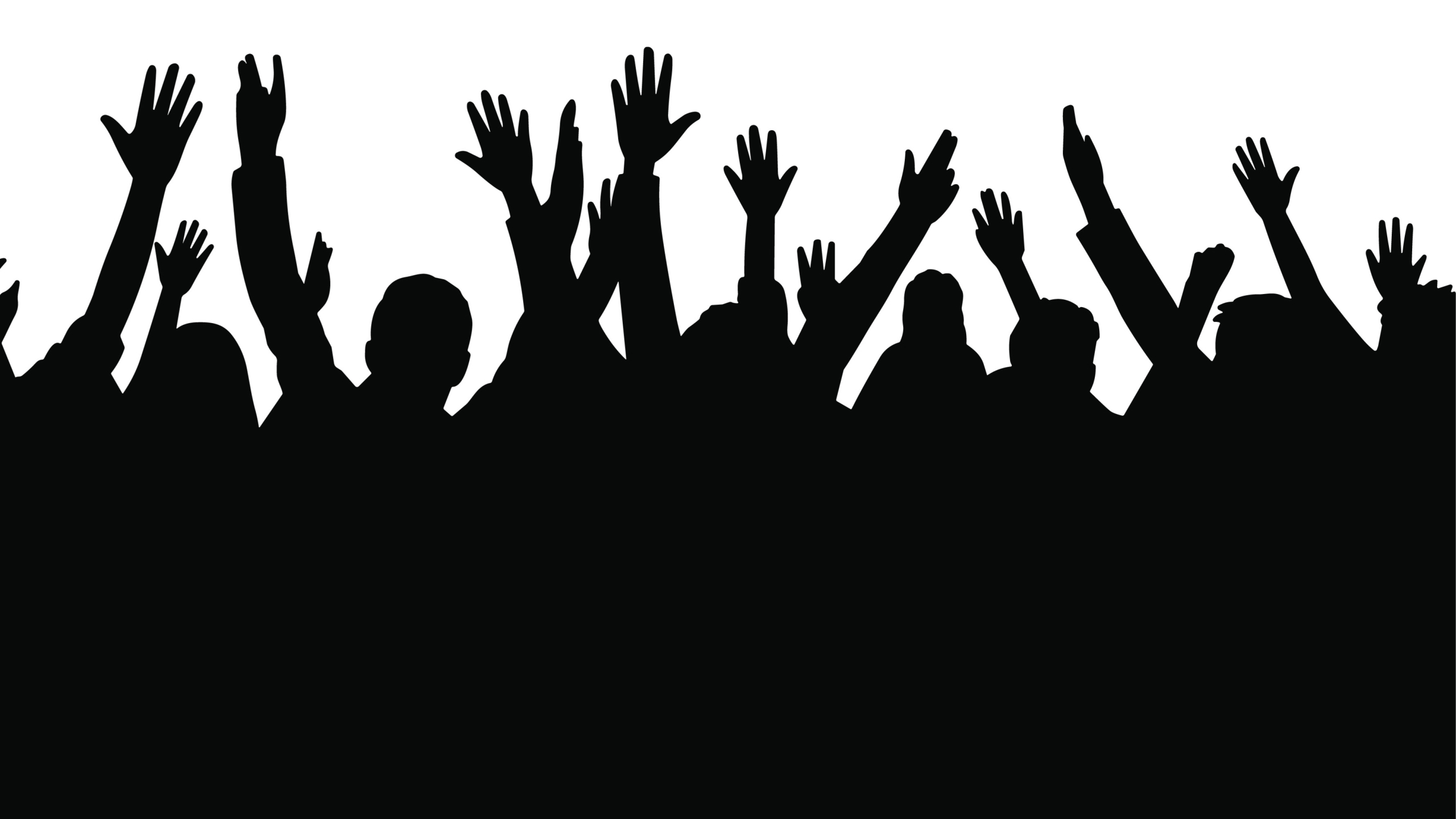 Silhouette of cheering crowd with raised hands at concert, festi