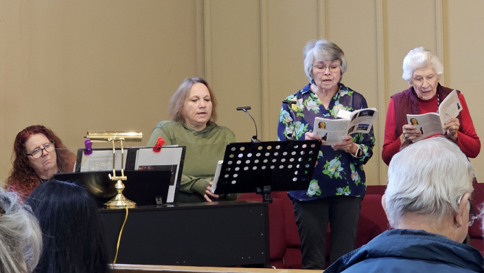 20260131_113852_Lakota Music_LR, Terry Schroeder, Toni Ramos, Choir~Attendees_NPM Winter Meeting_St Isaac Jogues,RC,SD_phtg MCN_CROP2_Lv.b00,w155,m0.95